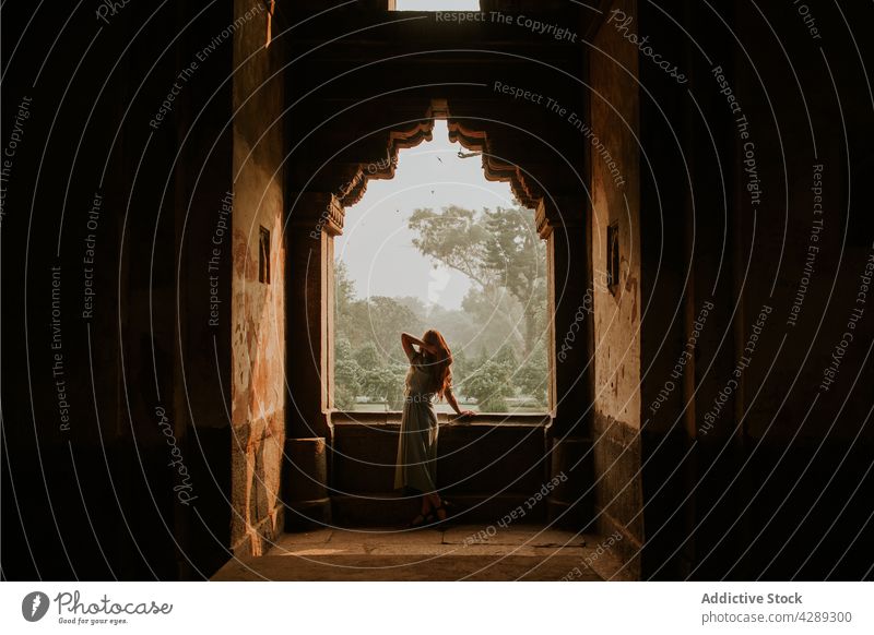 Woman standing in old sandstone mausoleum woman traveler admire sightseeing destination heritage holiday medieval landmark female vacation tourism culture