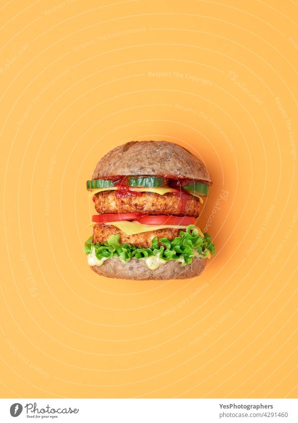 Veggie burger top view isolated on an orange background. above alternative bread bun cheese cheeseburger color consumerism cuisine cut out delicious dinner