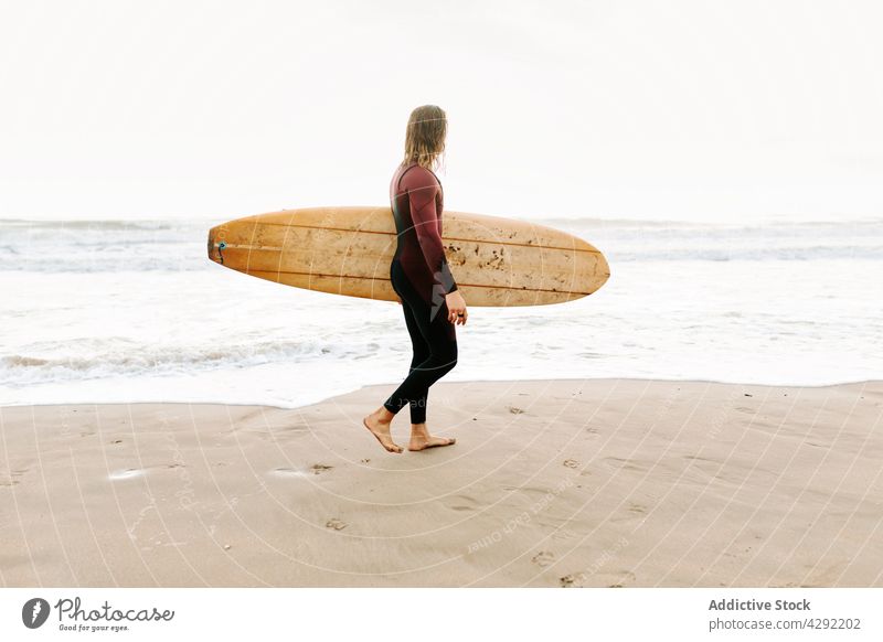 Anonymous surfer at the beach with surfboard man nature walking sunset wave outdoors wetsuit seacoast male sportsman surfing hobby ocean seaside calm catch