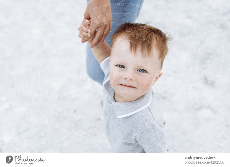 Portrait of a cute little boy on the background of white sand in the nature. Happy face is close. family happy fun child people father together young pond lake