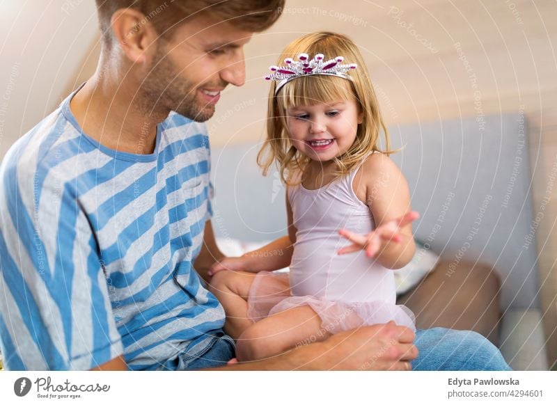 Father Playing with Daughter At Home home house man dad father family parent relatives child daughter girl little girl kid kids children relationship together