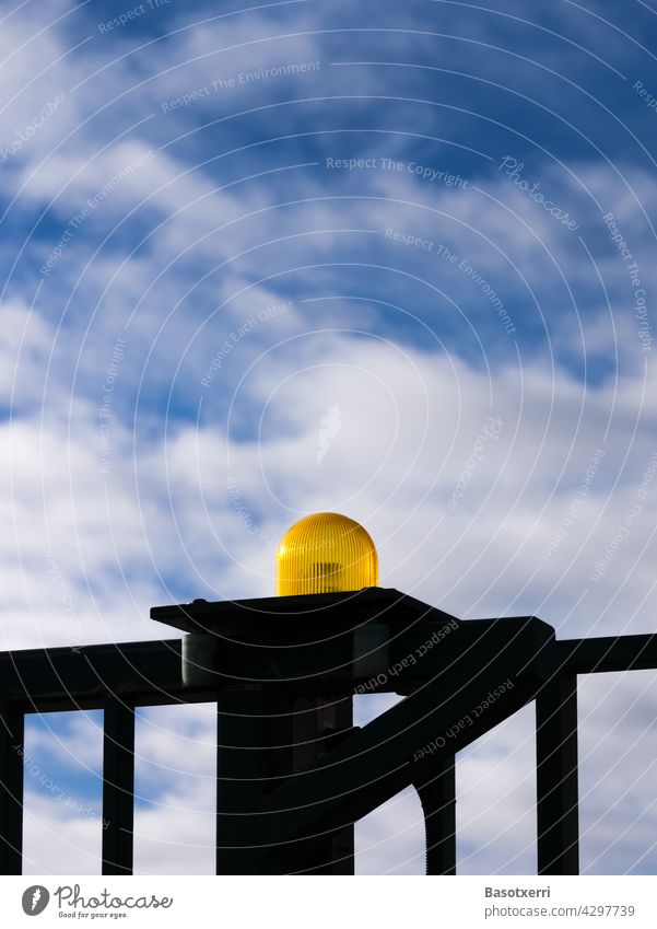 Yellow warning light at an automatic gate, blue sky and white clouds in the background Warning light Flash signal Goal Fence Gate peril Grating Movement Barrier