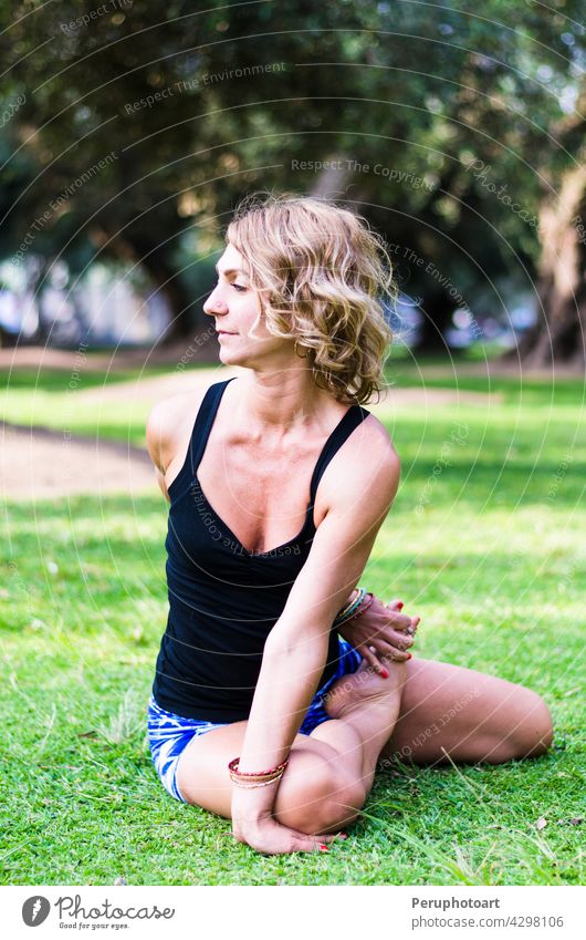 Pretty woman doing yoga exercises in the park. pose balance healthy sport girl people body morning relax lifestyle beautiful care female fitness relaxation slim