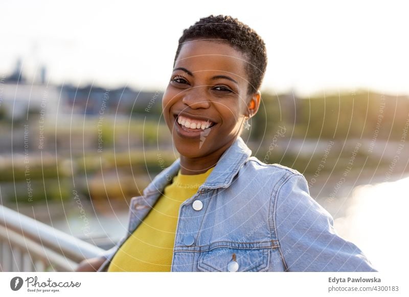 Portrait of a beautiful happy woman outdoors afro proud real people city life African american afro american student Black ethnicity sunny sunset outside pretty