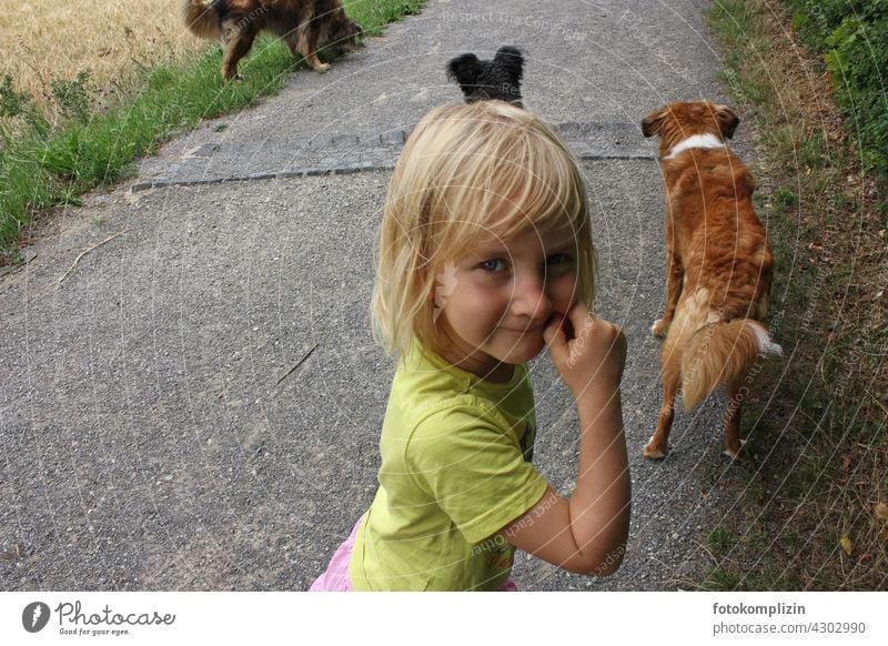mischievous look of child with dogs in background Child Dog Impish cheerful Pet Watchdog Love of animals off walk Walk the dog Outdoors Infancy Looking