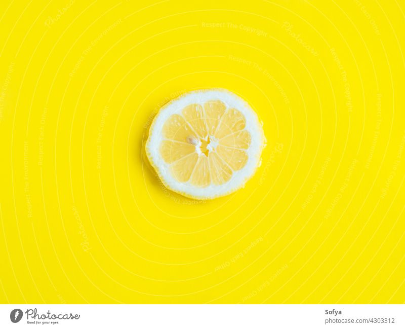 Intense yellow lemon citrus slice in water, texture summer background fresh fruit food vitamin color pattern cut flatlay flat lay liquid healthy juicy lemonade