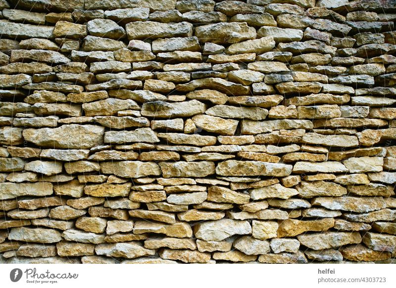 Wall with natural stones artfully laid as a beautiful background Wall (barrier) Wall (building) Natural stone Facade house wall Exterior shot Nature