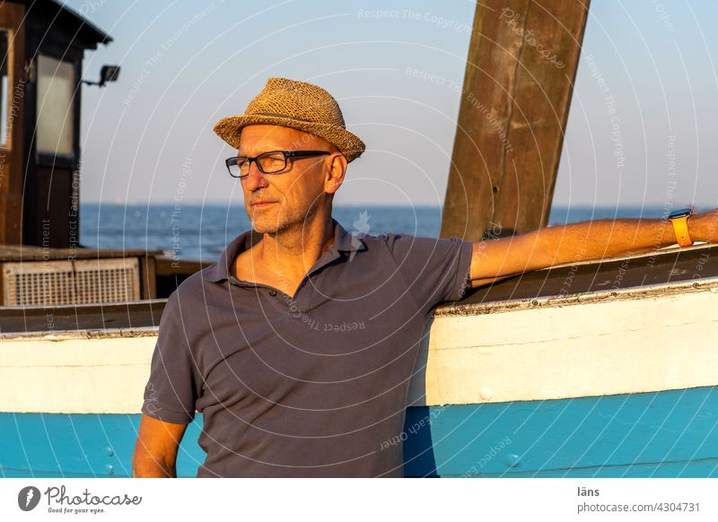 Man in front of fishing boat Vacation & Travel Tourism Colour photo Beach Maritime coast Blue Copy Space top Baltic Sea Ocean Usedom Island Beautiful weather