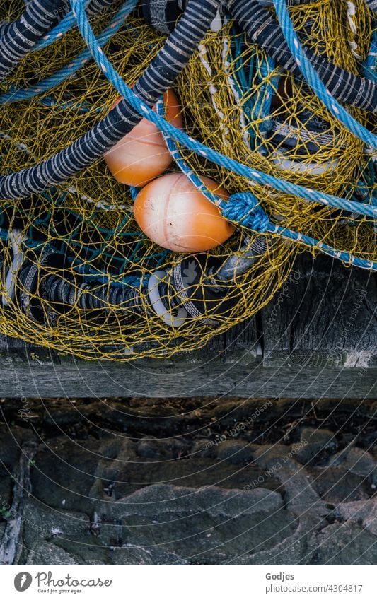 Fishing net lies on a jetty fishing Fishery Net Colour photo Exterior shot Network Day Fishing (Angle) Catch Harbour Fishing port Reticular buoys Orange Blue