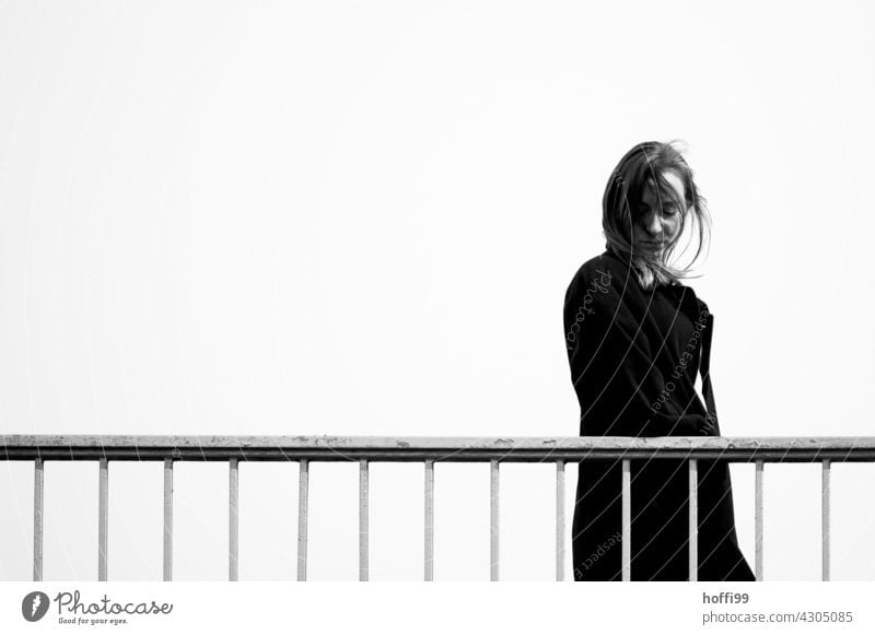 the young woman walks over a bridge and looks down Long-haired Looking away Fashion 18 - 30 years Hair and hairstyles Feminine Lifestyle Beauty Photography