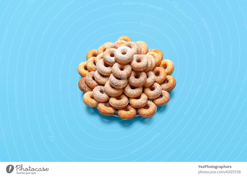 Doughnuts on a plate, isolated on a blue table. Sugar-coated mini donuts abundance background bake bakery breakfast cake color confectionery cuisine cut out
