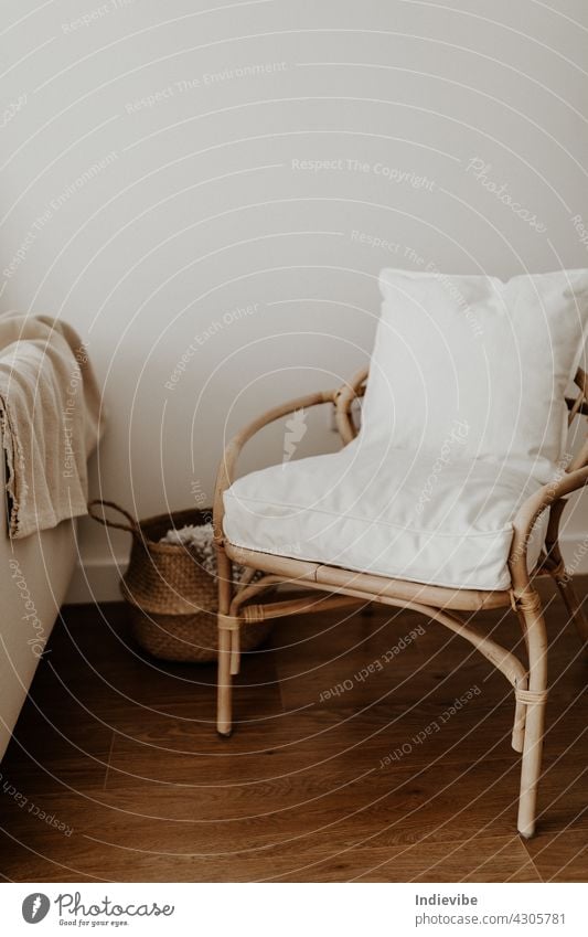 Rattan chair and basket, pillows and blanket in an empty room comfortable rattan apartment bamboo nobody beige contemporary decoration cozy cozy interior