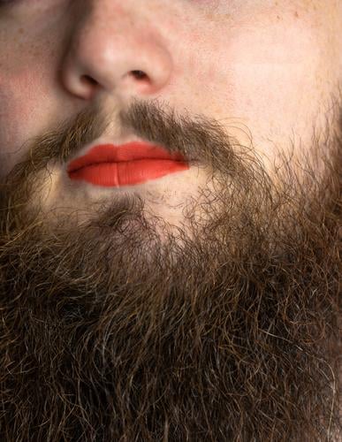 Bearded Man with Red Lipstick on His Lips , handsome pride transgender portrait lgbtq, transsexual concept lipstick beard red makeup man mouth face model