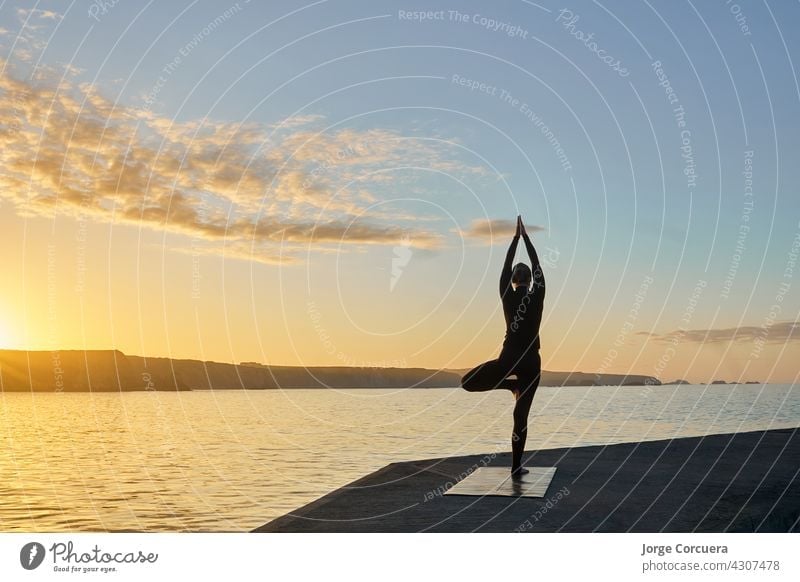 silhouette of woman practicing yoga in backlight young fitness slim workout exercise pose lifestyle caucasian female position training healthy activity person