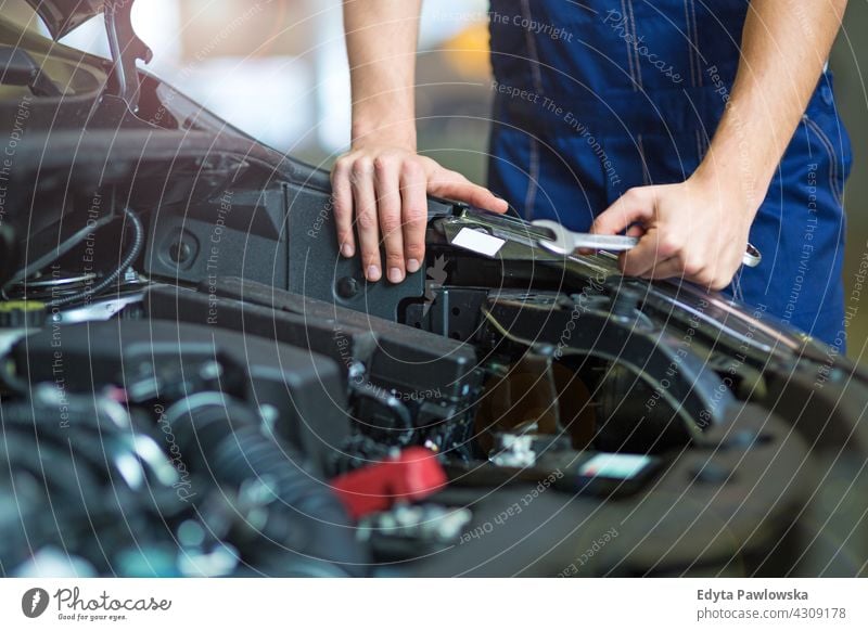 Mechanic showing dirty hands in car workshop - a Royalty Free Stock Photo  from Photocase