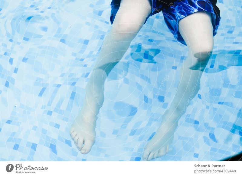 Legs in the pool swimming pools Swimming pool Water bathe splashing Cooling Summer Sun ardor cooling Swimming trunks Surface of water Summer vacation Blue