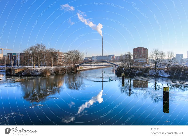 View over the north harbour to the Kiel bridge . in the background is a smokestack . Nordhafen moabit Winter Reflection Chimney Thermal power station vattenfall