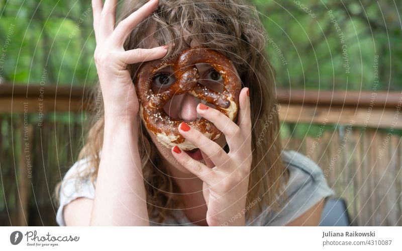 Woman with pretzel in front of her face Pretzel Baked goods Delicious Bavaria Oktoberfest Food Dough Bavarian Nutrition Breakfast Colour photo Snack Brunch