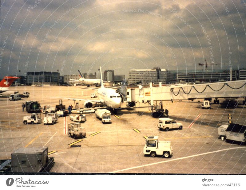 airport bustle Vacation & Travel Aviation Clouds Airport Vehicle Car Airplane Runway Driving Gray clouds Scan Gangway Colour photo