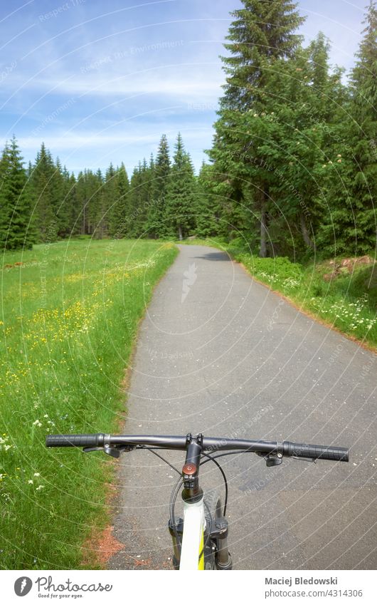 Road in Jizera Mountains, view from above bike steering wheel, Poland. mountains road trip adventure mountain bike Izera sport cycling nature forest landscape