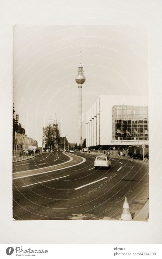 The black and white photo from the 1970s shows the Berlin TV Tower and a part of the Palace of the Republic / GDR architecture / analogue photography