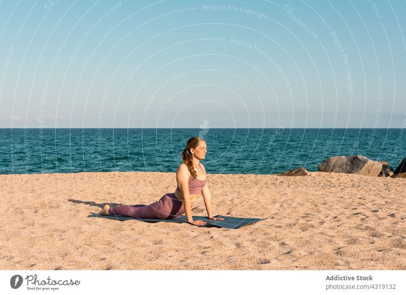 Woman doing boat yoga pose on the beach stock photo (238147) -  YouWorkForThem