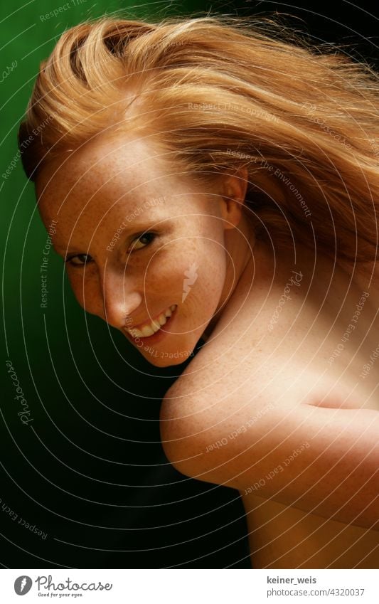 Redhead woman shows skin with freckles and smiles at the camera Woman Red-haired portrait Naked Skin Feminine Hair and hairstyles Freckles Green Laughter