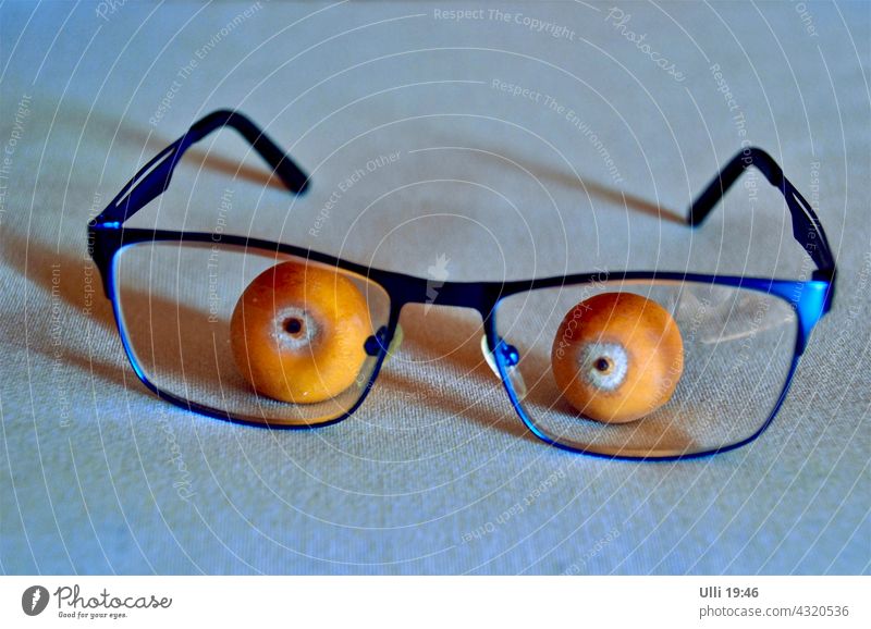 Palm fruit with reading glasses. Table decoration Eyeglasses Reading glasses Palm tree Palm Fruit tablecloth funny action amusing idea eyes blue glasses Orange