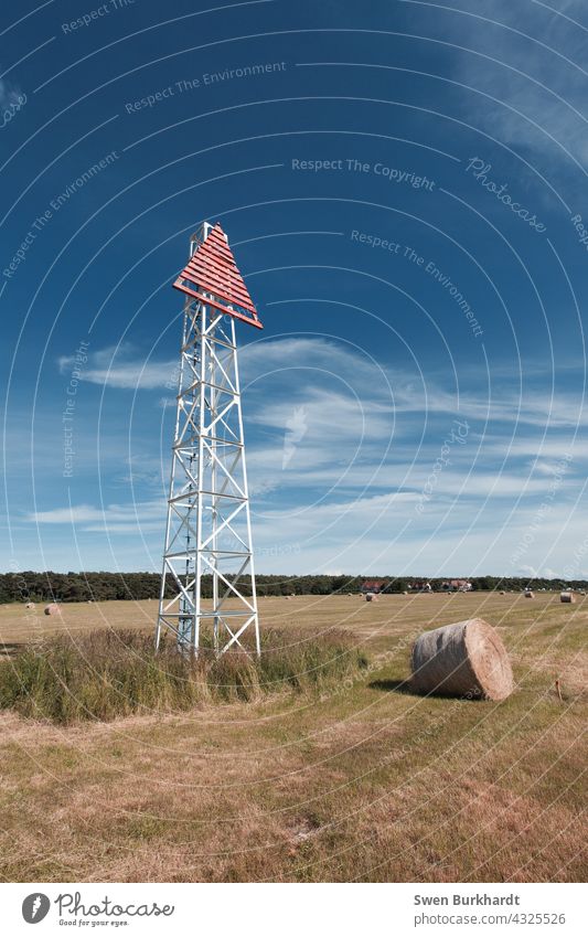 Sea sign stands on field next to a roll of hay against blue sky Navigation mark Blue sky Sky Summer Hay Hay bale Harvest Autumn Summery Clouds Tower Dirty