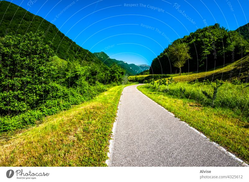 2021 06 13 Lessini road in the valley spring country nature landscape green asphalt summer rural way countryside sky highway travel blue grass field tree