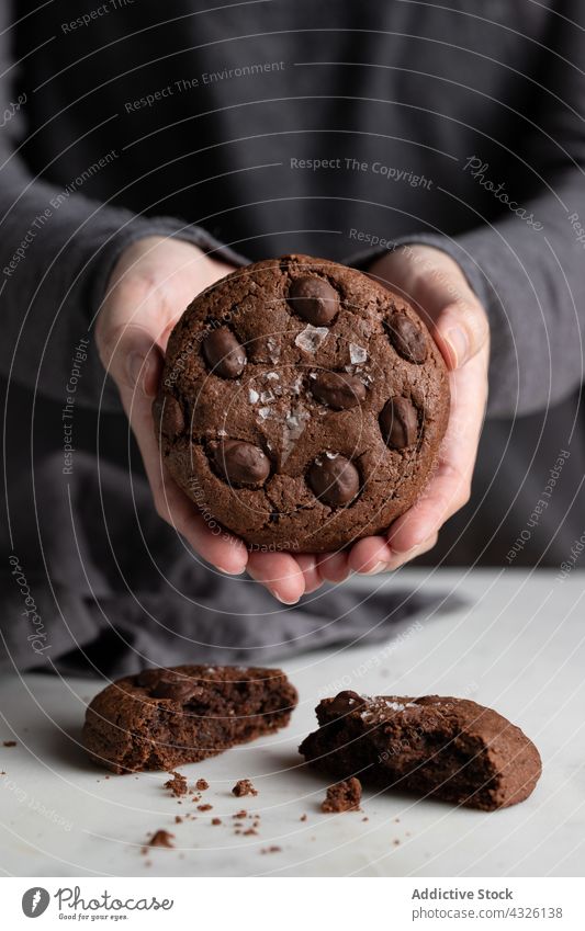 Crop person with chocolate cookies rye sweet dessert kitchen delicious tasty homemade pastry yummy biscuit snack bakery culinary baked treat recipe prepare