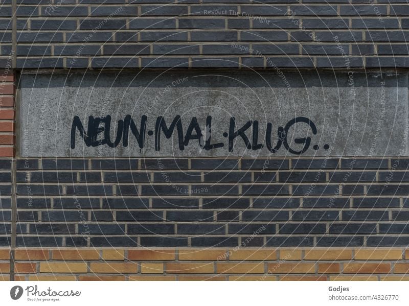 NeunMalKlug writing on the wall of a university building lettering Graffiti Characters Wall (building) Wall (barrier) Exterior shot Copy Space top