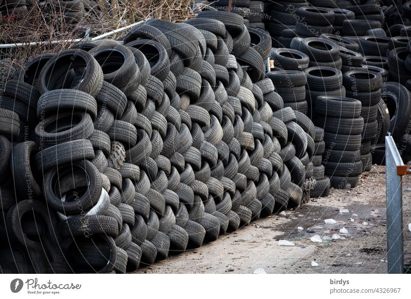 Stacked car tires in a scrap tire dump Car tire scrap tyres Tyre landfill stacked Waste tyre landfill Disposal Trash Recycling waste rubber abrasion Wear Tire