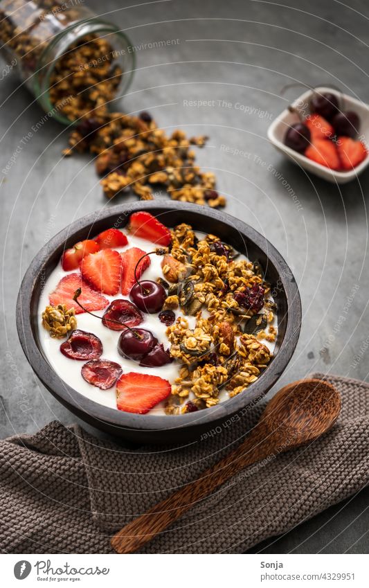 Granola with yogurt and strawberries in a bowl on a rustic table Breakfast cereal bowl granola Strawberry Yoghurt Morning Rustic Spoon Wood Healthy Eating
