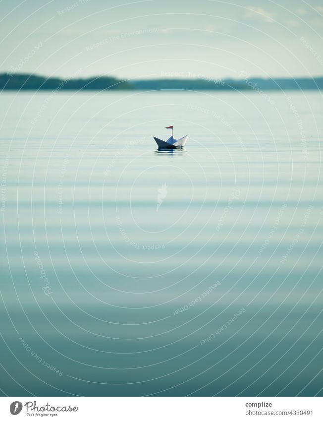 Calm lake with small paper boat Freedom Sunbeam Sunlight coast Sailboat Target Paper boat Navigation Infancy Beach Summer vacation Water Nature Environment