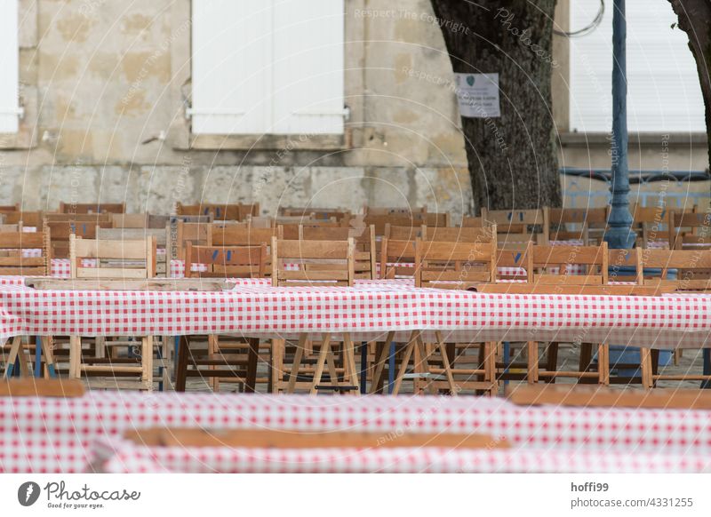 Rows of chairs and tables on a marketplace await guests festival party folk festival food and drink Eating celebrations empty chairs Table Rustic Tradition