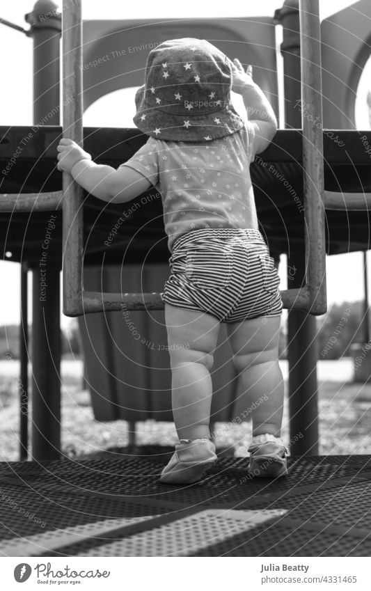 13 month old baby trying to navigate a ladder at a playground; reaching and pulling up to tip toes pull up tiptoe learn learning hold vestibular sensory input