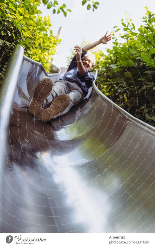 Man at work | Park Tour HH21 Slide Skid Adult man Exterior shot Day Playing Playground Joy Deserted Infancy Joie de vivre (Vitality) Happiness Movement