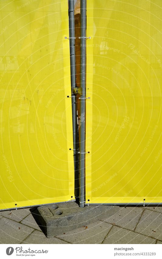 Building site detail in yellow and grey Construction site Hoarding Construction site fencing Yellow Gray Exterior shot Deserted Safety Protection Fence Barrier