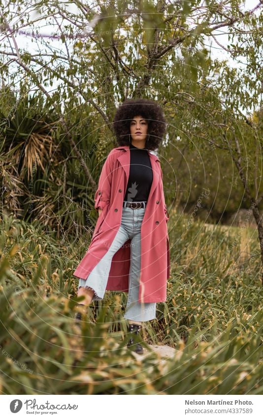 Portrait of a beautiful young mixed afro woman outdoors golden hour clothes weather person cute female nature people clothing stylish fashion ethnic lady coat