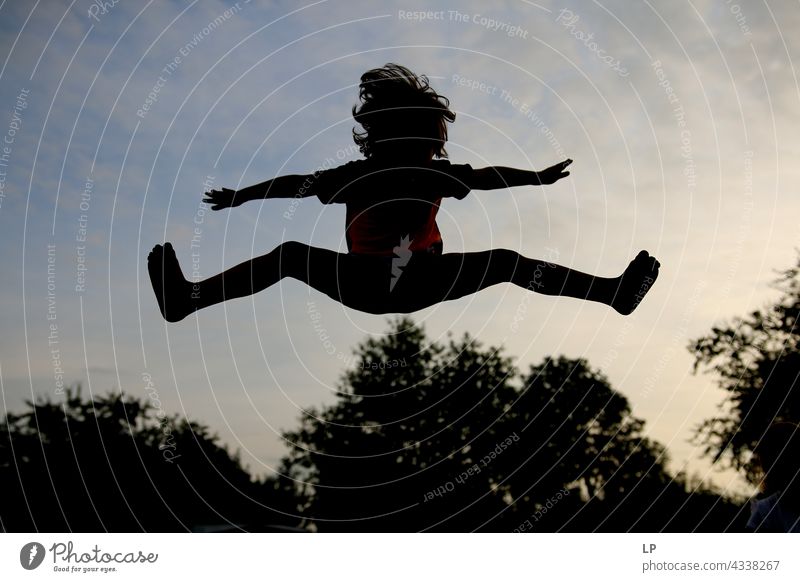 contrast silhouette of a child jumping above trees outdoor recreation Structures and shapes Playing Harmonious Well-being Neutral Background Day Beginning