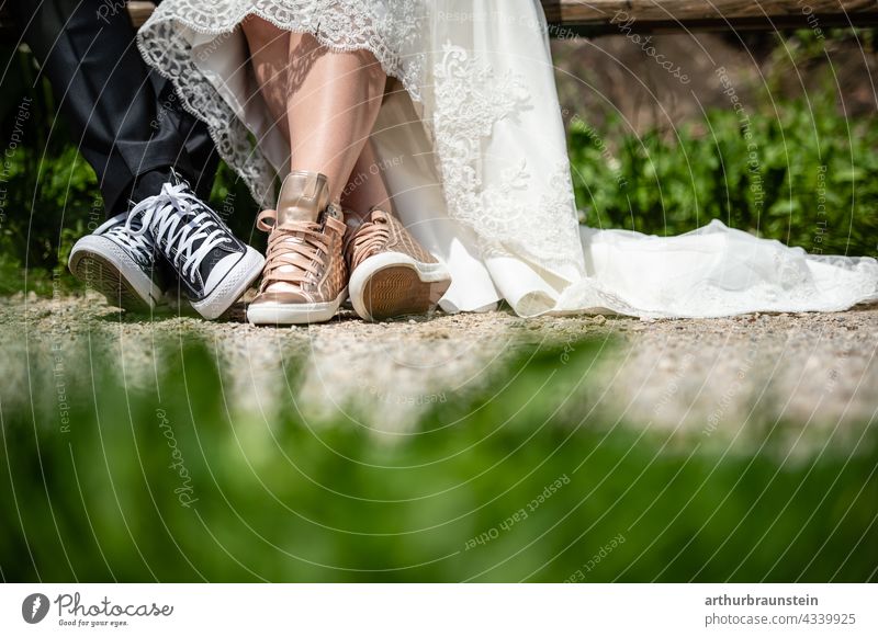 Young wedding couple in sneaker shoes sitting on a bench in nature Wedding Love Couple Exterior shot Lovers Wedding couple Relationship Partner Matrimony 2