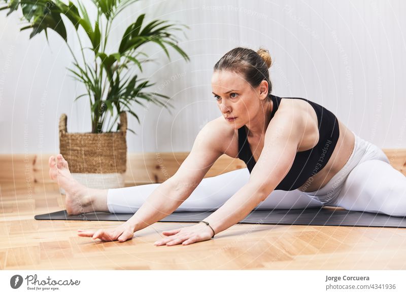 partial detail of Russian woman practicing yoga nood on a mat female exercise pilates body girl training hair stretching yogi young adult aerobics asana balance
