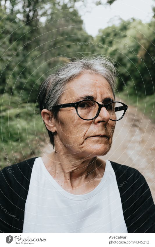 Thoughtful serious anxious mature senior woman, pensive sad lady looking away thinking of loneliness, getting older and depression person age alone bored