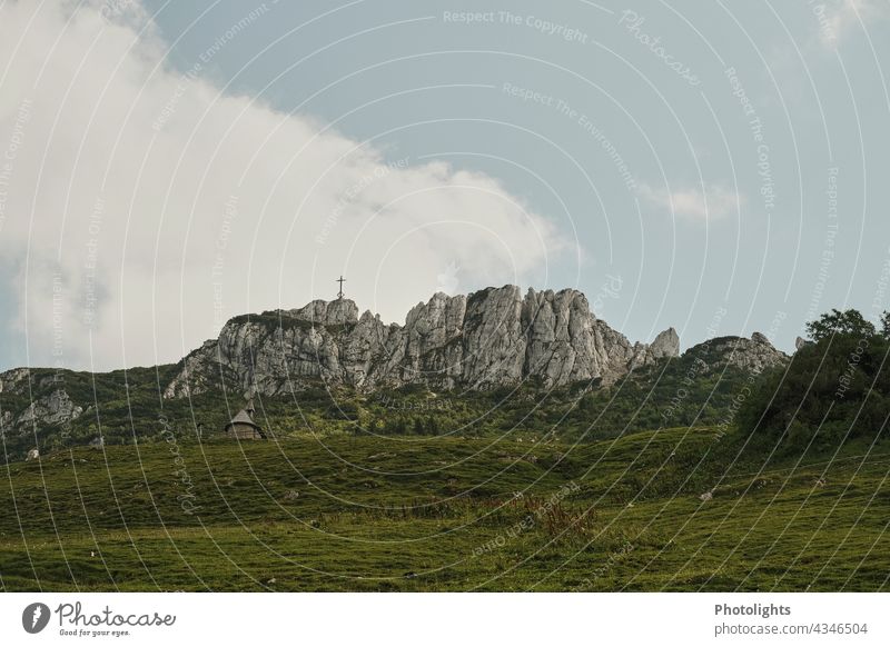 Kampenwand with summit cross. Mountain near Aschau in Chiemgau mountain Peak camping wall Rock Peak cross look Stone Willow tree Grass Gray Green Tree Alps