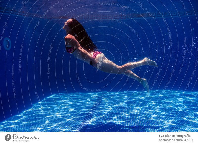 caucasian woman diving in swimming pool. underwater view. Summer time and vacation concept fun summer love blue water sunny day outdoors relax happy beautiful