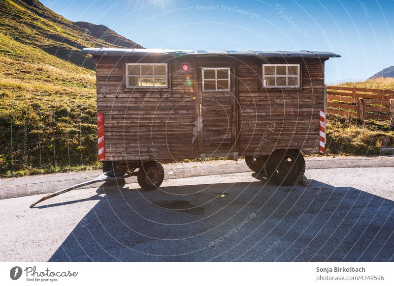 Wooden construction trailer parked in the mountains Site trailer Carriage Trailer Colour photo Exterior shot Caravan Old Nature Day Deserted Landscape out Light