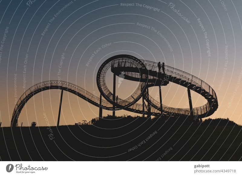 Turning loops (only for those who are free from giddiness) Roller coaster Leisure and hobbies Multicoloured Exterior shot Sky Blue Copy Space top Joy Sun Sunset