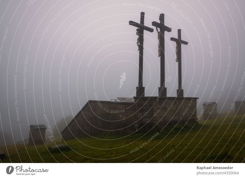 Three crosses on Kreuzberg mountain in Rhoen, rainy summer day architecture atmosphere blue catholic christian christianity church clouds crucifix dark death