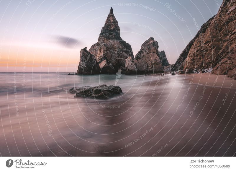 Rocky sea stacks at Portugal Ursa Beach at Atlantic Ocean coast in sunset light. Foamy waves rolling on picturesque landscape vacation scene atlantic beach ursa